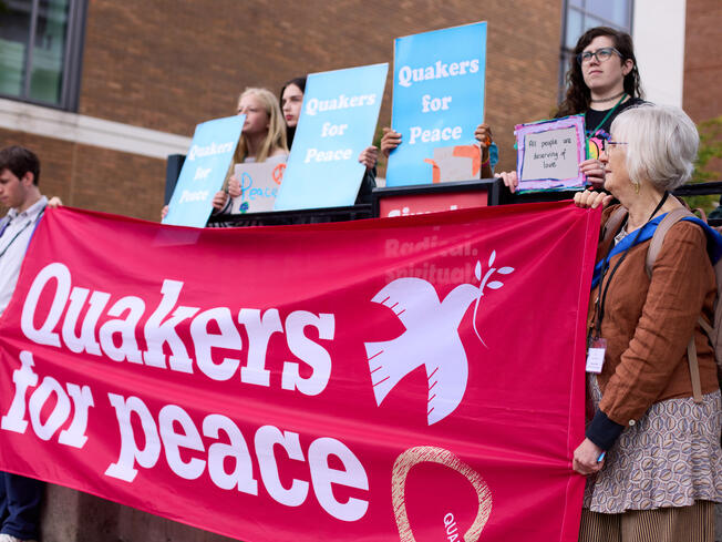 A group of Quakers holding signs saying Quakers for Peace