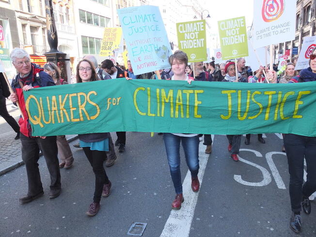 People marching under Quakers for Climate Justice banner